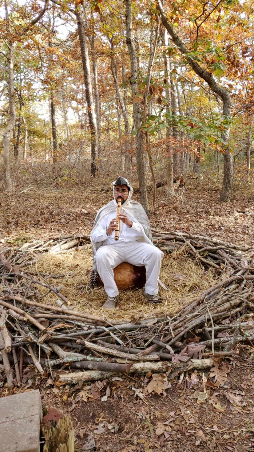 Tonito playing flute in a forest nest